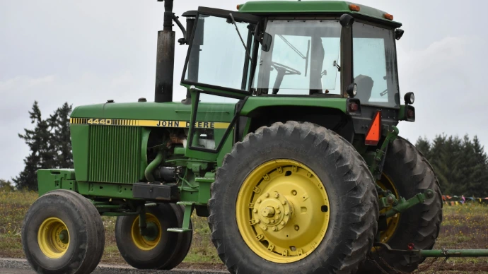 green tractor on brown soil